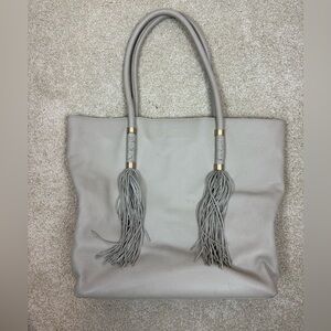 VINCE CAMUTO | Dessa Pebbled Leather tassel Tote in parchment light gray tan